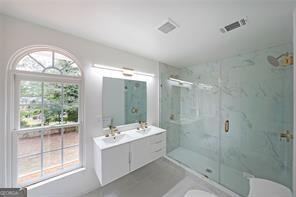 bathroom featuring vanity and a shower with shower door