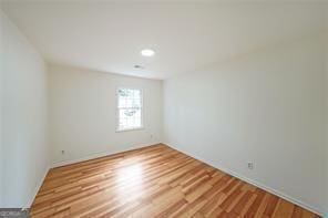 unfurnished room with hardwood / wood-style floors