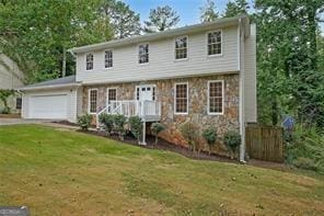 view of front of house featuring a front yard and a garage