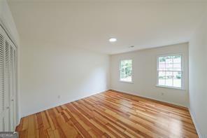 unfurnished bedroom featuring a closet and light wood-type flooring