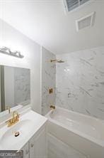 bathroom with shower / bathing tub combination and vanity