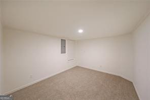 spare room featuring carpet flooring and electric panel