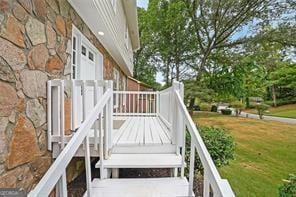 wooden deck with a lawn