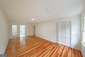 unfurnished bedroom with hardwood / wood-style floors and a closet