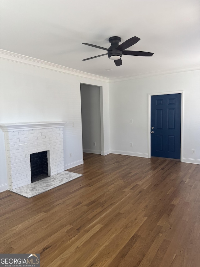 unfurnished living room featuring ceiling fan, dark hardwood / wood-style floors, ornamental molding, and a fireplace