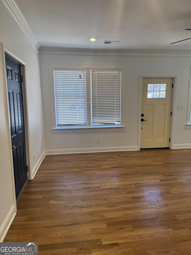 foyer entrance featuring dark hardwood / wood-style floors and ornamental molding