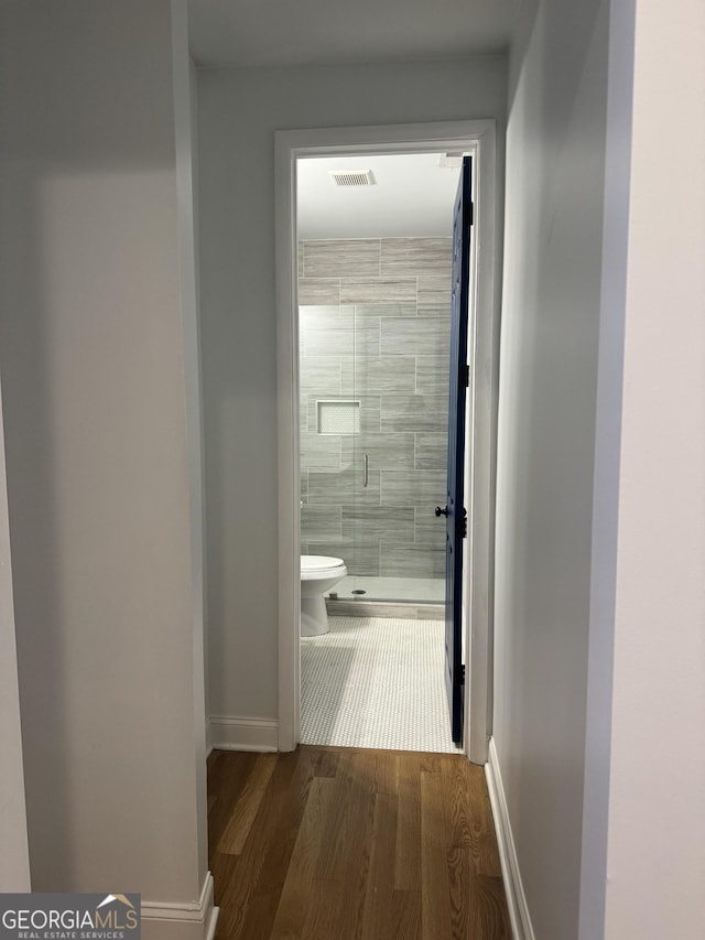 hallway with dark hardwood / wood-style flooring