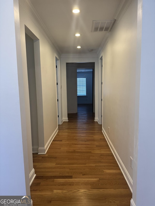 hallway featuring ornamental molding and dark wood-type flooring