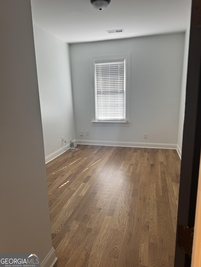 empty room with dark wood-type flooring