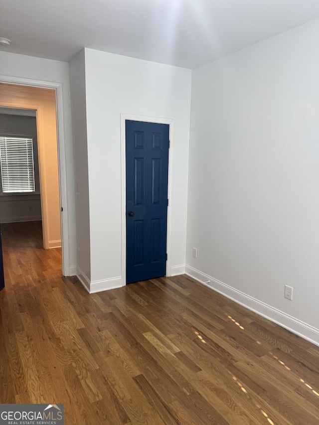 spare room with dark hardwood / wood-style floors