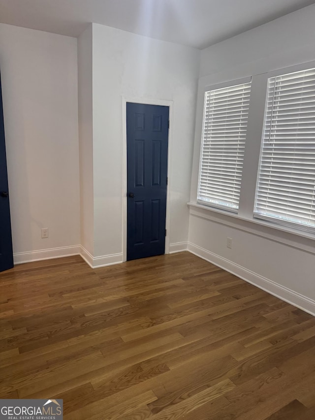 empty room with dark wood-type flooring