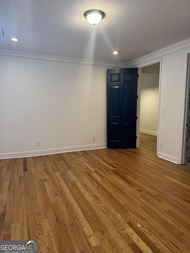 basement with crown molding and hardwood / wood-style floors