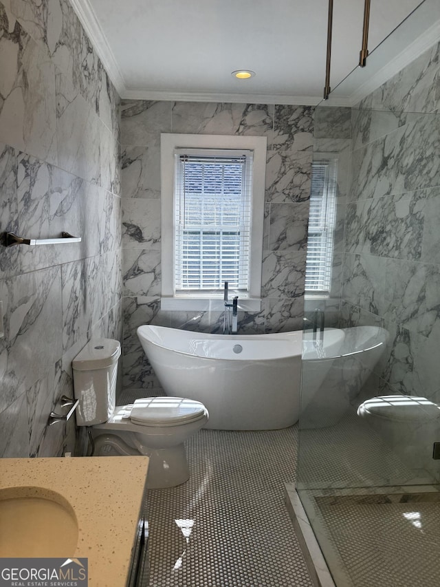 bathroom with a washtub, vanity, crown molding, tile walls, and toilet