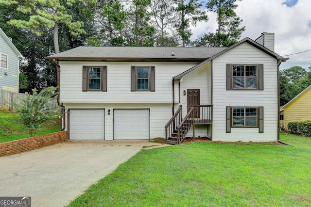 raised ranch featuring a front yard and a garage