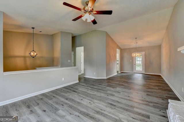 unfurnished living room featuring ceiling fan, wood-type flooring, and lofted ceiling