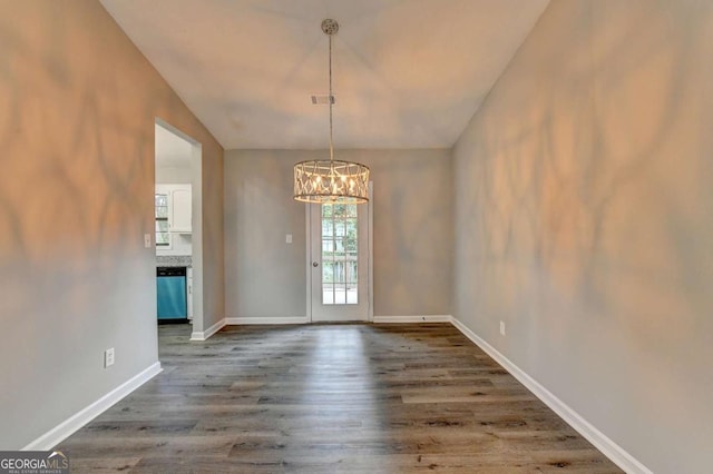 unfurnished dining area featuring hardwood / wood-style floors and a notable chandelier