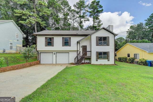 split foyer home featuring a front lawn and a garage