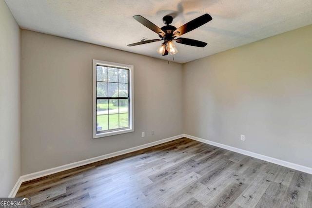 spare room featuring ceiling fan and light hardwood / wood-style floors