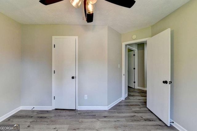 unfurnished bedroom featuring ceiling fan and light hardwood / wood-style flooring