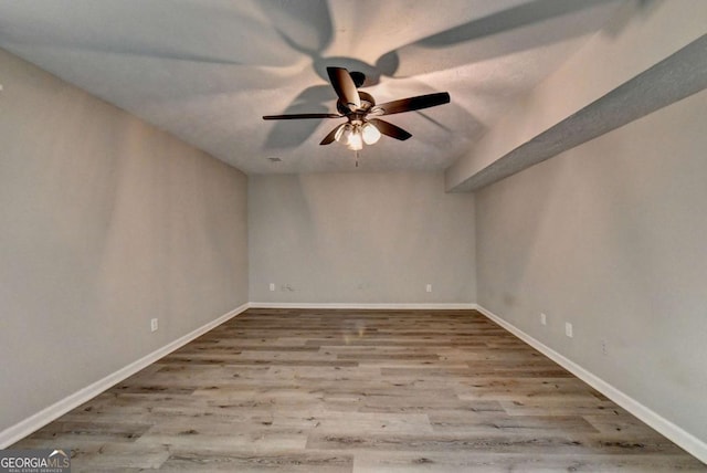 spare room featuring light hardwood / wood-style flooring and ceiling fan