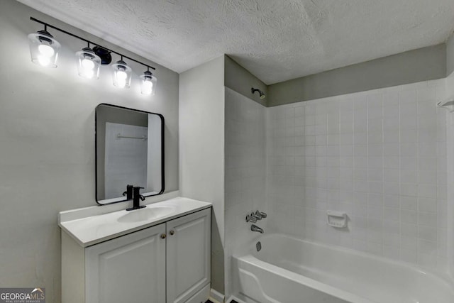 bathroom featuring vanity, a textured ceiling, and bathtub / shower combination