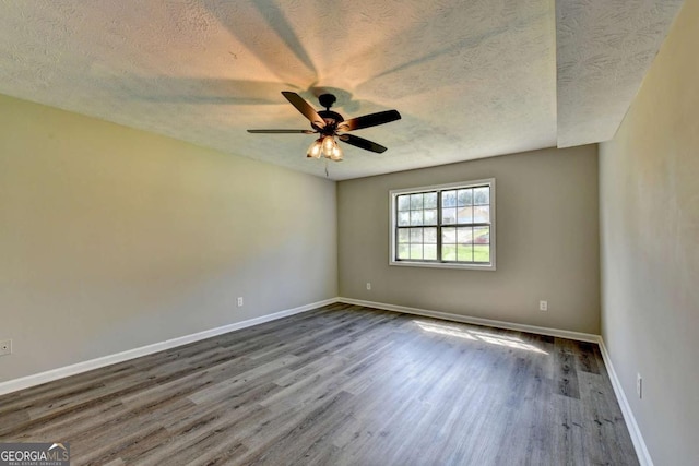 spare room featuring ceiling fan, hardwood / wood-style floors, and a textured ceiling