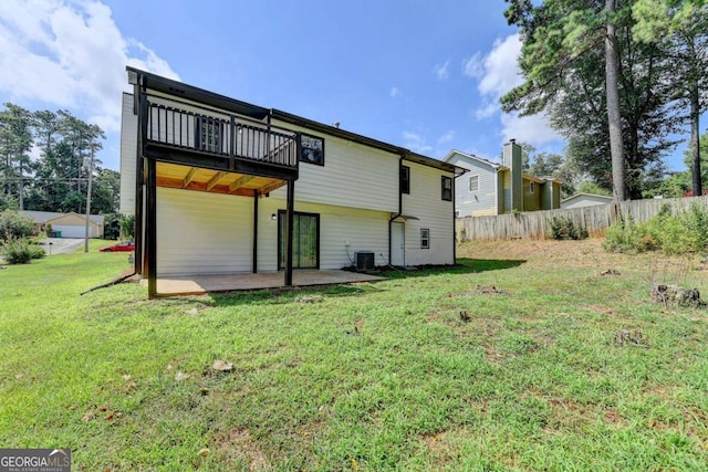 rear view of house with a yard, a patio, central AC unit, and a deck