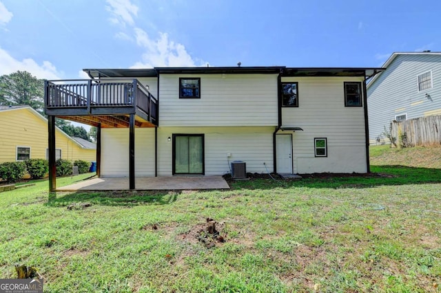 back of property featuring cooling unit, a yard, a patio, and a wooden deck