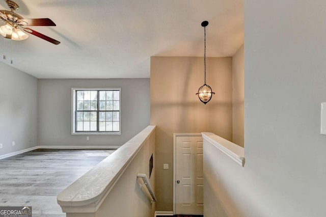 corridor with hardwood / wood-style flooring