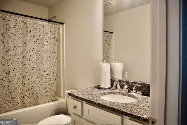 full bathroom with vanity, toilet, and shower / bath combo with shower curtain