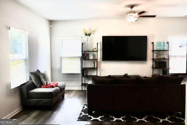 living room featuring hardwood / wood-style flooring and ceiling fan