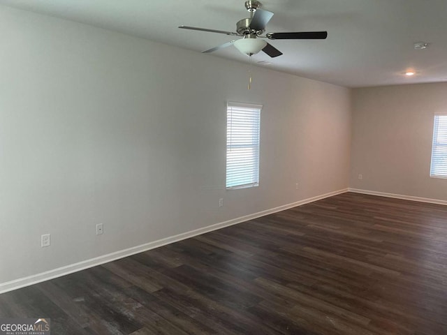 unfurnished room featuring dark hardwood / wood-style floors and ceiling fan