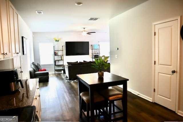 dining room featuring ceiling fan and dark hardwood / wood-style floors