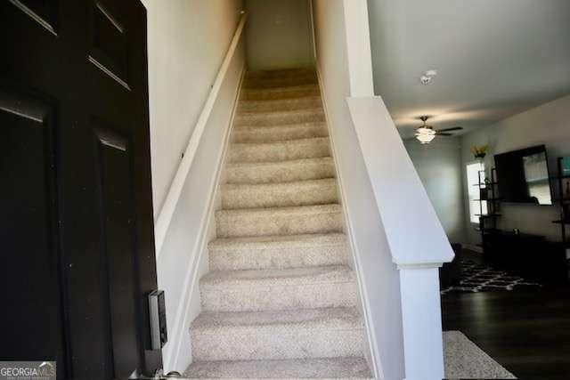 stairway with ceiling fan