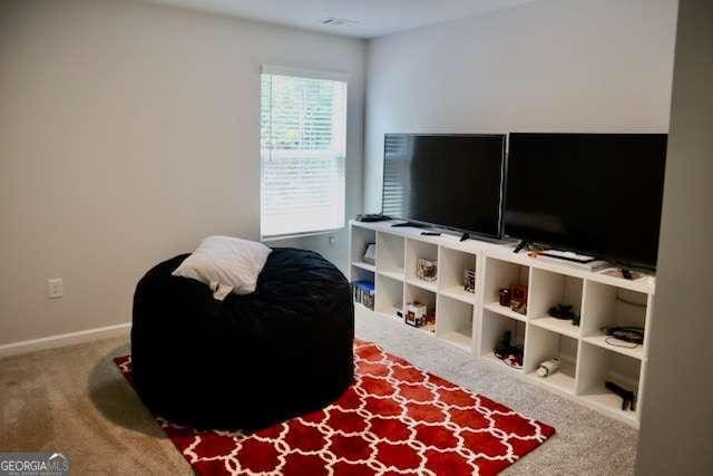 living area featuring carpet floors