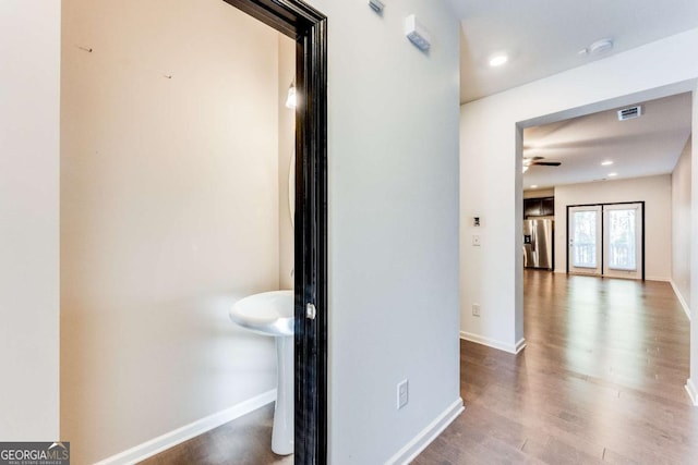 hallway with hardwood / wood-style floors