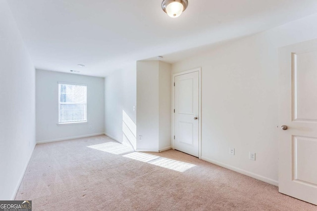 spare room with light colored carpet