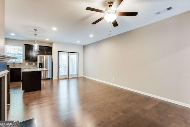 living room featuring ceiling fan and dark hardwood / wood-style flooring