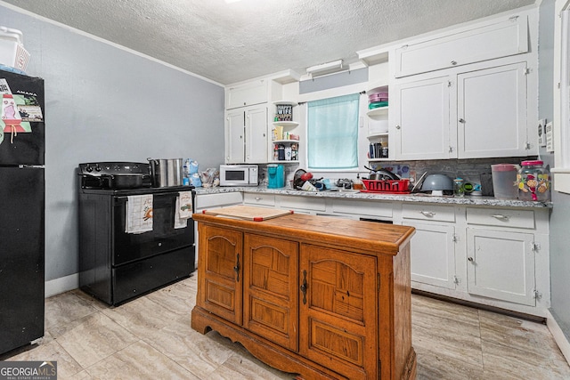 kitchen with black appliances, decorative backsplash, white cabinetry, and a textured ceiling