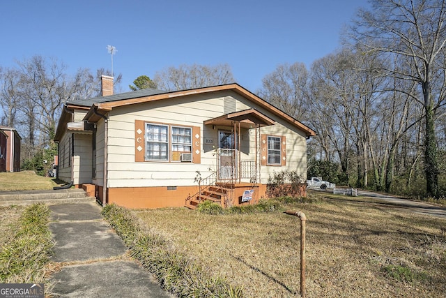 bungalow-style home featuring a front lawn