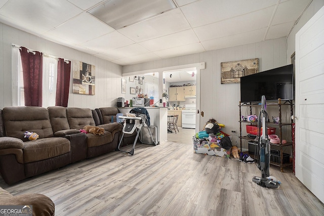 living room with a paneled ceiling and wood-type flooring