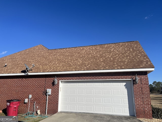 view of side of home featuring a garage