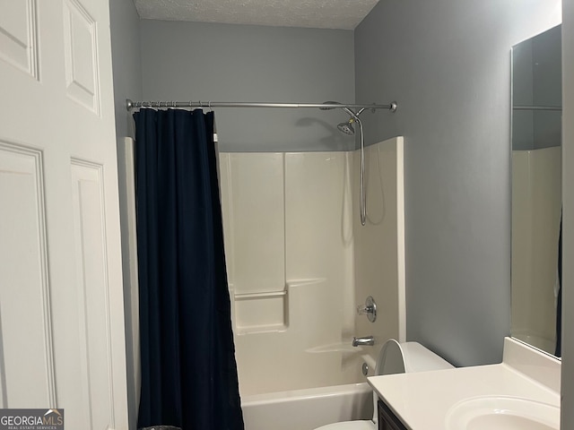 full bathroom featuring shower / bath combo, toilet, a textured ceiling, and vanity