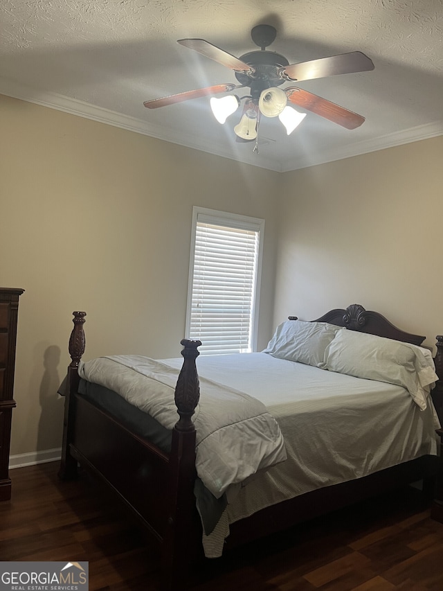 bedroom featuring a textured ceiling, dark hardwood / wood-style floors, ceiling fan, and ornamental molding