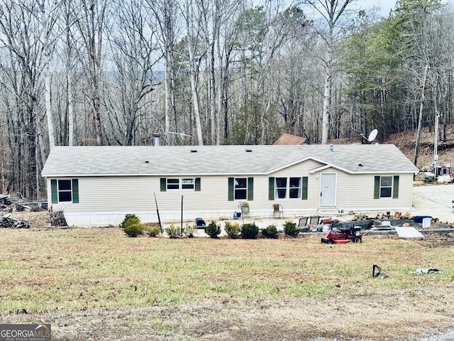 rear view of property with a lawn