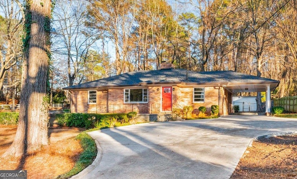 single story home featuring a carport