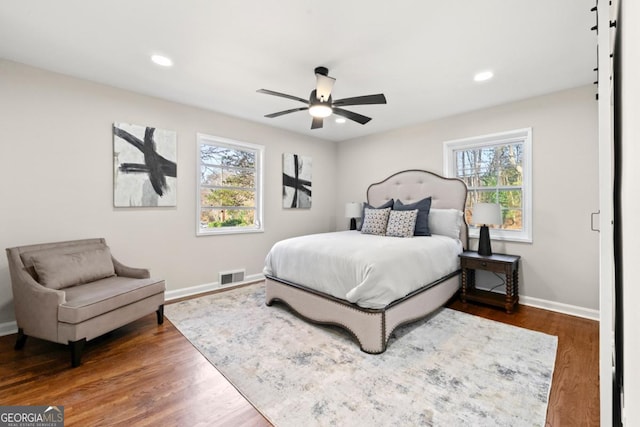 bedroom with ceiling fan and dark hardwood / wood-style floors