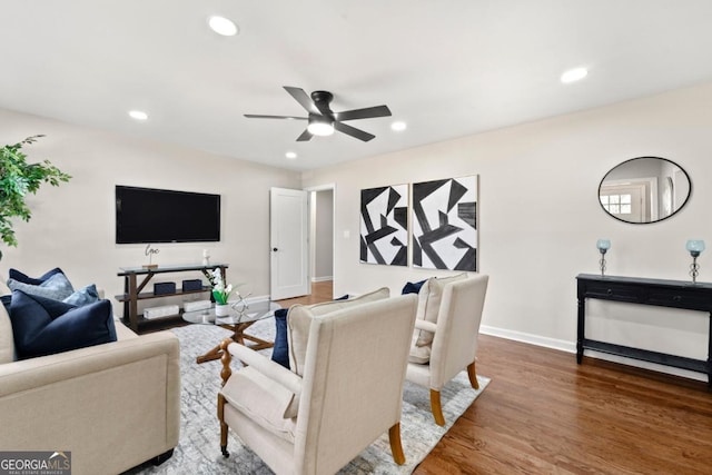 living room featuring ceiling fan and wood-type flooring