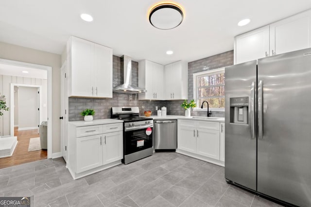 kitchen with white cabinets, sink, wall chimney exhaust hood, and stainless steel appliances