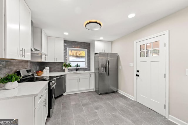 kitchen with white cabinetry, sink, stainless steel appliances, backsplash, and extractor fan